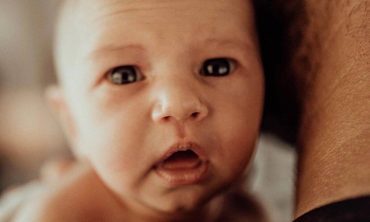 Νεογέννητη μπέμπα ποζάρει στον φακό επαγγελματία φωτογράφου