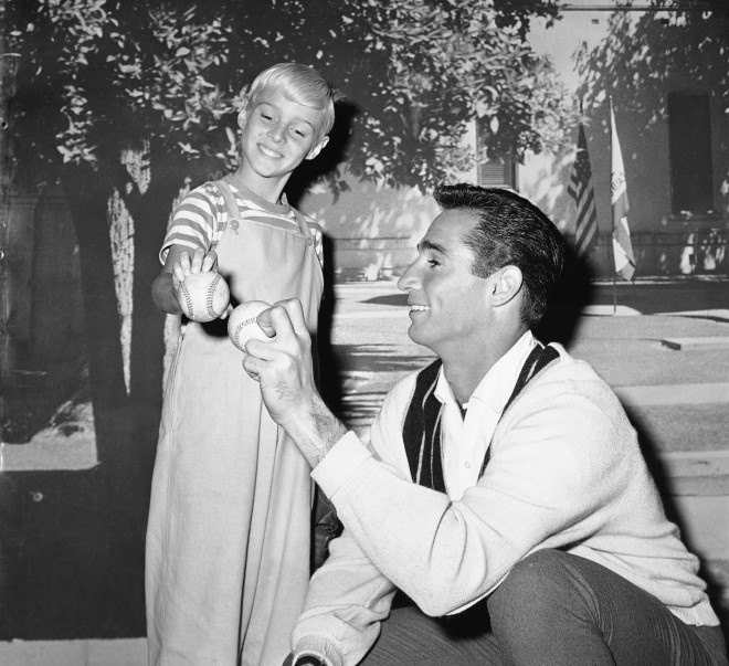 Sandy Koufax, Los Angeles Dodgers’ pitcher, gives TV star Jay North some pointers on pitching on Feb. 22, 1962. Koufax is appearing briefly on the “Dennis the Menace” series in which young North has the title role. (AP Photo/David F. Smith)