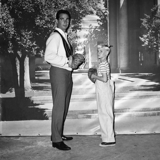 Sandy Koufax, Los Angeles Dodgers’ pitcher, gives TV star Jay North some pointers on pitching on Feb. 22, 1962. Koufax is appearing briefly on the “Dennis the Menace” series in which young North has the title role. (AP Photo/David F. Smith)